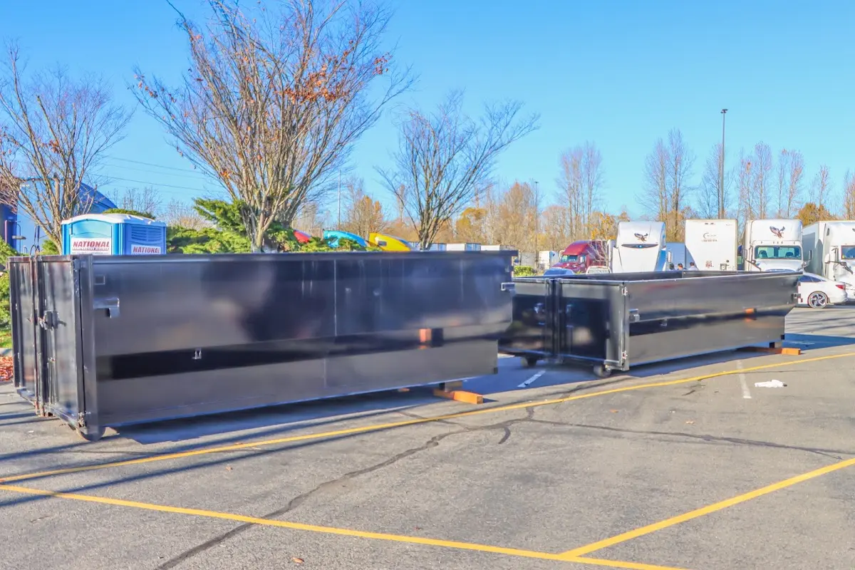 Professional dumpster rental service with roll-off container on residential driveway in Brookfield